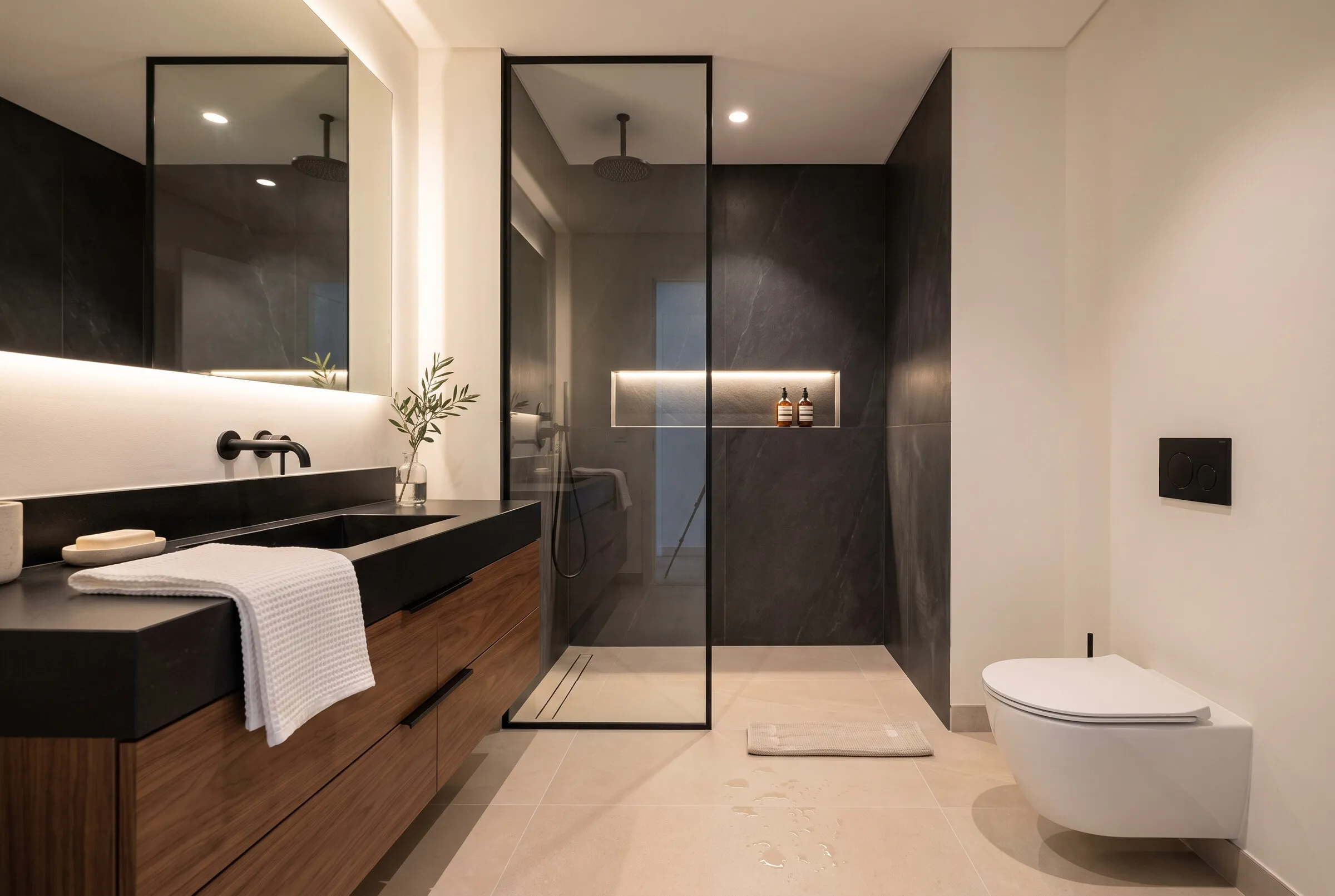 Bathroom: walnut vanity, glass shower, dark porcelain stoneware